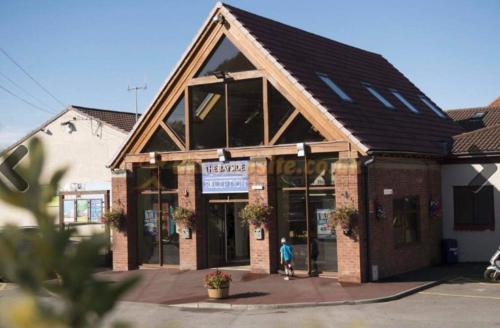 a building with a person standing outside of it at Angella's Caravan - Morecambe in Morecambe