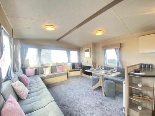 a living room with a couch and a table at Angella's Caravan - Morecambe in Morecambe