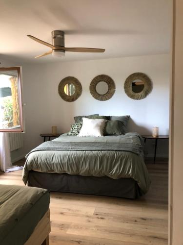 a bedroom with a bed and mirrors on the wall at Appartement Rez de Jardin in Cavalaire-sur-Mer