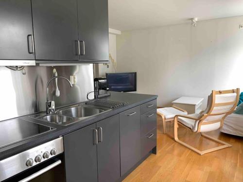 a kitchen with a sink and a counter top at Leilighet i hjertet av kristiansand sentrum! in Kristiansand