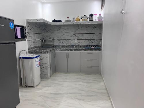 a small kitchen with a sink and a refrigerator at Hotel apartment america in Dakhla