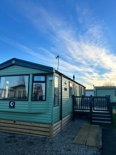 a green house with a roof on top of it at Swift Retreat Caravan - Morecambe in Morecambe