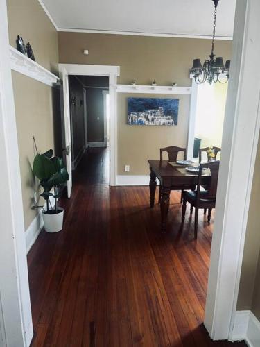 a living room with a table and a dining room at Historical Hideaway at Jacksonville in Jacksonville