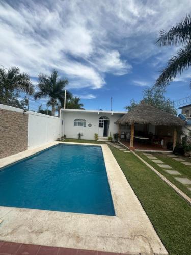 a swimming pool in front of a house at Casa Gaviota Casa Con Alberca y Palapa in Tequesquitengo