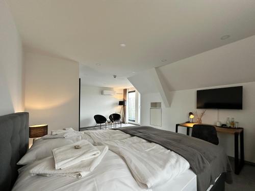 a bedroom with a large bed with a flat screen tv at SI-View Doppelzimmer mit Stadtblick Zimmer 16 in Siegen