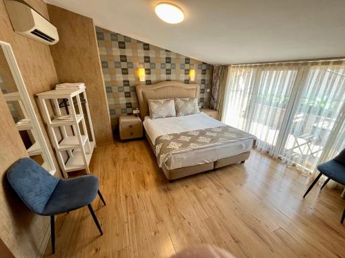 a bedroom with a bed and a chair in it at Meydan Suites in Istanbul