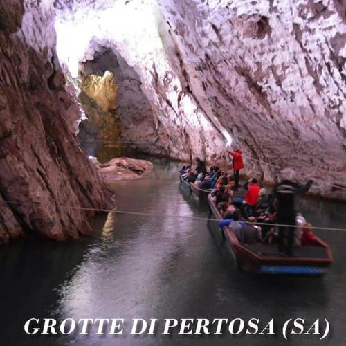 a group of people riding in boats in a cave at Casa Semeria Certosa di Padula(SA) in Padula