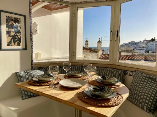 a table in a room with a view of a city at Ocean Balcony apartment terrace sea view and pool in Albufeira