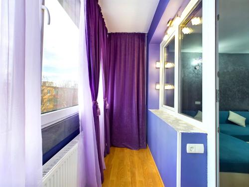 a room with purple curtains and a window at Toni’s place in Braşov