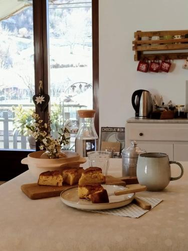 a table with a plate of food on a counter at Lo noú b&b in Aosta
