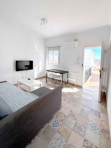 a bedroom with a bed and a table in it at Gran Teatro Falla in Cádiz