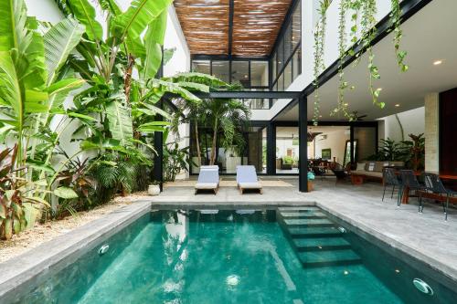 an indoor pool in a house with plants at Casa Aventura Secluded Oasis 24h Security Near Sandy Beaches in Tulum
