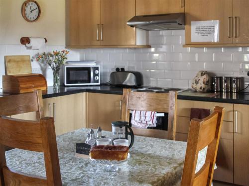 a kitchen with a table and a counter top with a tableablish at Millstone Cottage - Uk46676 in Highley