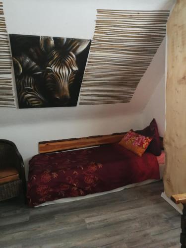 a bed in a room with a painting on the wall at Gästehaus Fuchsröhre in Welcherath