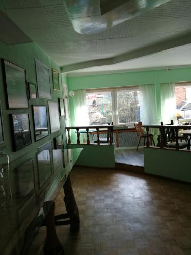 a room with green walls and pictures on the wall at Gästehaus Fuchsröhre in Welcherath
