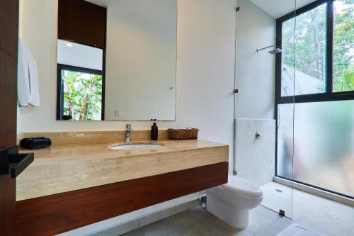 a bathroom with a sink and a mirror at Casa Aventura Secluded Oasis 24h Security Near Sandy Beaches in Tulum