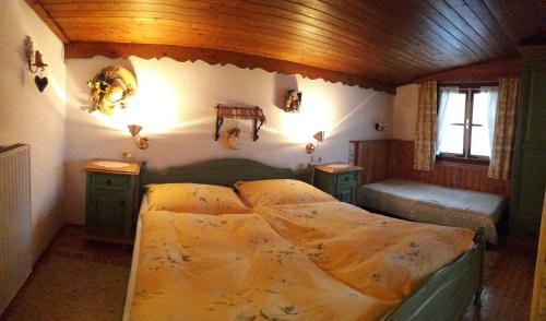 a bedroom with a large bed in a room at Pension Kirchleitn in Turnau
