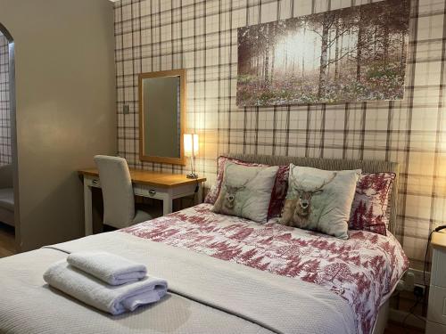 1 dormitorio con 1 cama con 2 toallas en Little Connaught House en Portsmouth