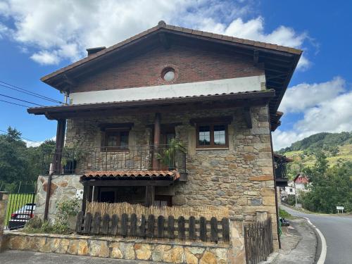 a stone house on the side of a road at K13 in Concha