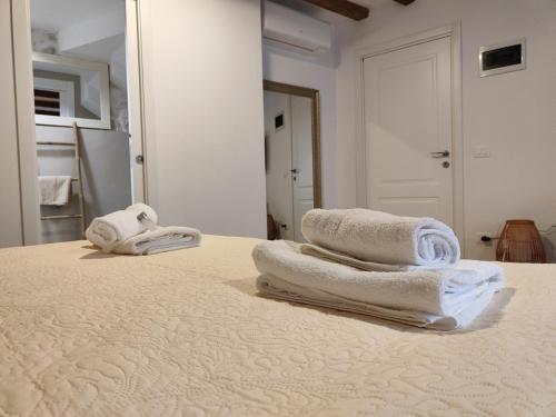 two towels are sitting on top of a bed at Casa di Luna Rovigno in Rovinj