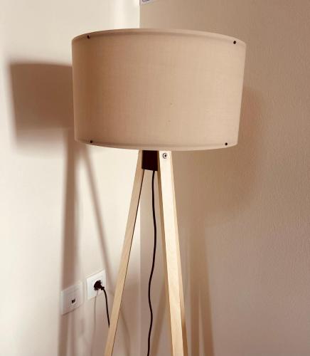 a lamp with a white lampshade in a room at Central House Karistos Two in Karistos
