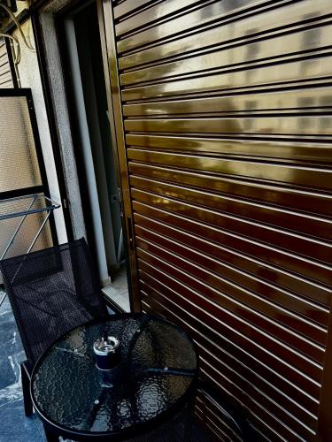 a table and a fence with a wooden door at Central House Karistos Two in Karistos