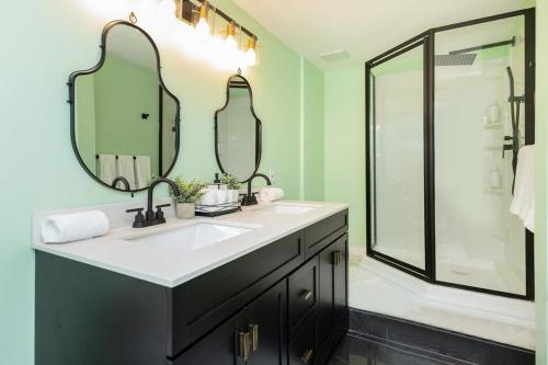 a bathroom with a sink and two mirrors at 4BR Modern Home with Sunny Patio in Ottawa
