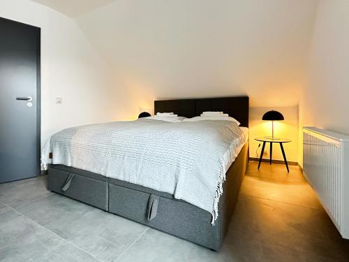 a bedroom with a large bed and a table at SI-View Doppelzimmer Zimmer 23 in Siegen