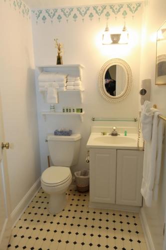 a bathroom with a white toilet and a sink at The Ocean Plaza Hotel in Ocean Grove