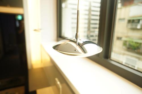 a lamp sitting on a window sill next to a window at Taipei Discover Hostel in Taipei