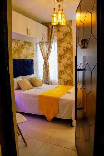 a bedroom with a bed and a chandelier at Blessed homes in Nairobi