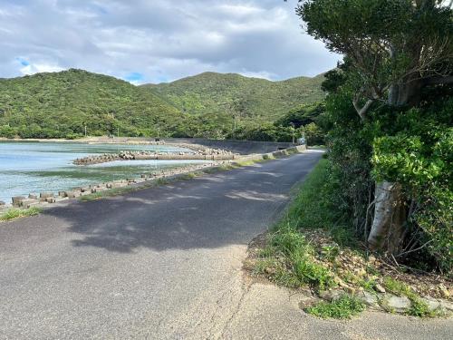 a road next to a body of water with mountains at Shishikura - Vacation STAY 47819v in Anan