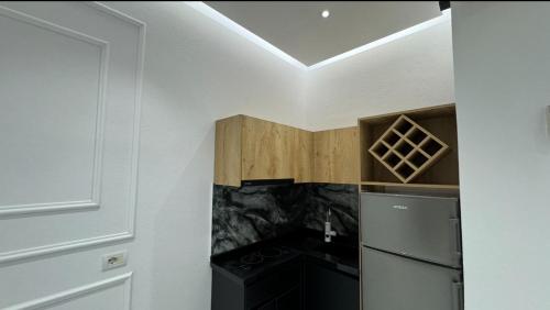 a kitchen with a stove and a refrigerator at Apartments Costa Azzurra in Velipojë