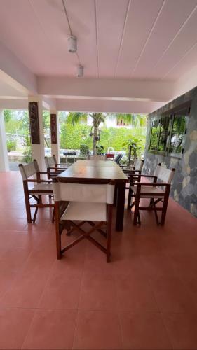 a dining room with a table and chairs at Aisawan Resort villa in Surin Beach