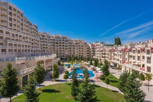an apartment complex with a large courtyard with a pool at Sunrise Luxury Sauth Bay in Varna City