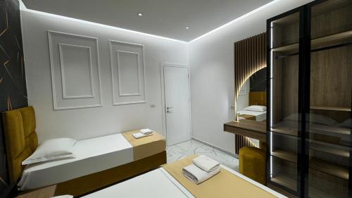 a small room with a bed and a bathroom at Apartments Costa Azzurra in Velipojë