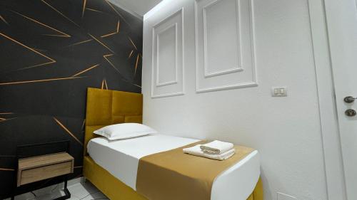 a small room with a bed and a chair at Apartments Costa Azzurra in Velipojë