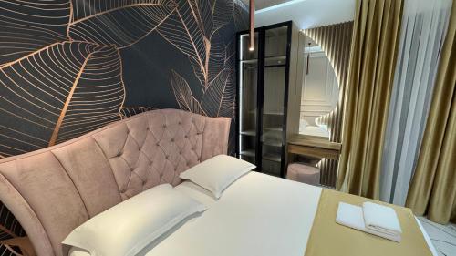 a hotel room with a bed and a chair at Apartments Costa Azzurra in Velipojë