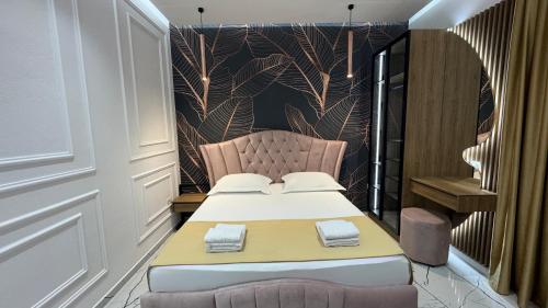 a bedroom with a bed and a chair in it at Apartments Costa Azzurra in Velipojë