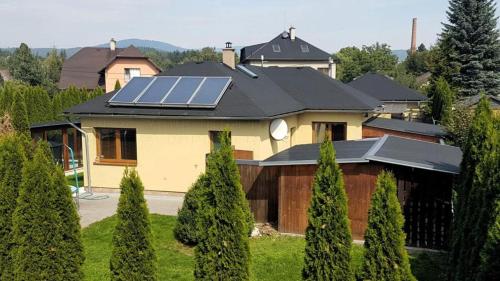 a house with solar panels on top of it at Vila MAX - WHIRLPOOL & BAZÉN & SAUNA in Velké Losiny