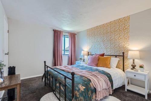 a bedroom with a bed and a window at 4bd Serene Escape Denver: BBQ;Firepit;Arcade in Westminster