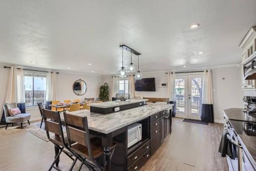 a kitchen and living room with a table and chairs at 4bd Serene Escape Denver: BBQ;Firepit;Arcade in Westminster