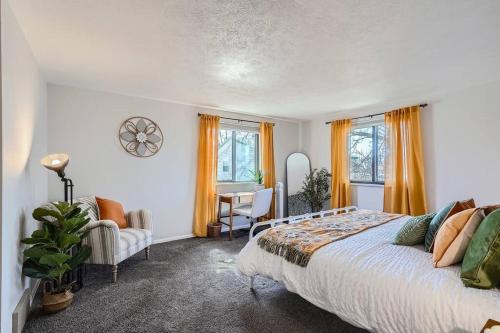 a bedroom with a bed and a table and chairs at 4bd Serene Escape Denver: BBQ;Firepit;Arcade in Westminster