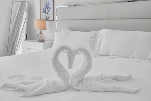 two towels in the shape of hearts on a bed at Deluxe 1 Bedroom Apartment • Brickell • Ocean View in Miami