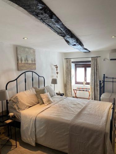 a bedroom with a large bed in a room at Casa Foelas The Garden Apartment in Casoli