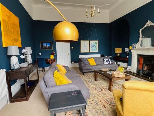 a living room with a couch and a fire place at Entire Stylish Colourful Two Bed Flat in Clifton in Bristol