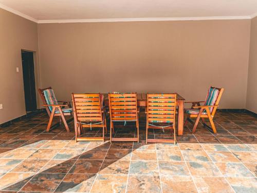 a dining room with a table and four chairs at Khutso Boutique Hotel in Hazyview