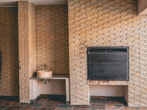 a brick wall with a sink and a window at Khutso Boutique Hotel in Hazyview