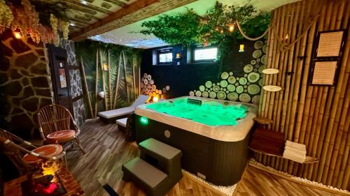 a room with a tub with a pool table at PARADiSE Wellness Residence in Terchová