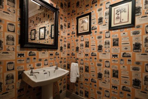 a bathroom with a sink and a mirror at Broadgate House & Steading in West Woodburn